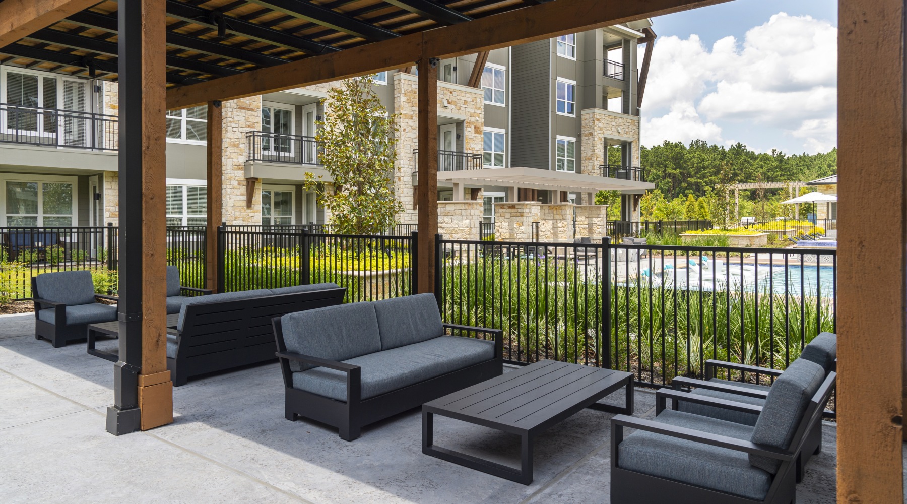 an outdoor lounge area with couches, tables and chairs