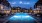 Large resort style pool with large pool deck at night